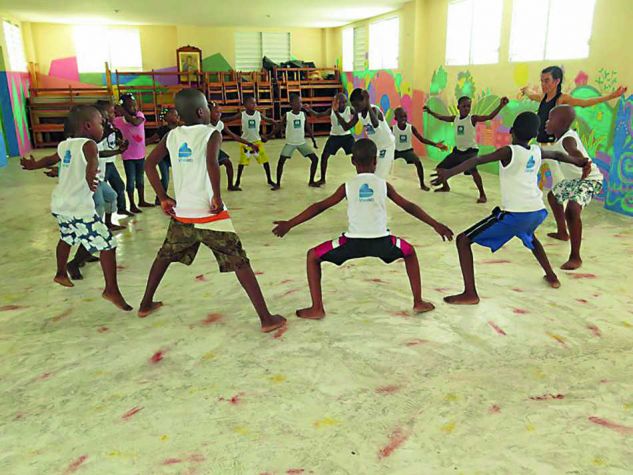 Children practicing Capoeira, which combines elements of dance, acrobatics and music